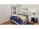 Cozy bedroom with hardwood floors, a queen-sized bed, and natural light from the window at 3085 Duneville St, Las Vegas, NV 89146