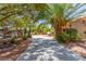 Long driveway leading to home with mature trees, lush landscaping and a decorative fountain at 3085 Duneville St, Las Vegas, NV 89146