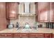 Close-up showcasing the kitchen's stainless steel stove, granite countertops, and decorative backsplash at 3085 Duneville St, Las Vegas, NV 89146