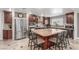 Spacious kitchen with a large island, stainless steel appliances, and rich wood cabinetry at 3085 Duneville St, Las Vegas, NV 89146
