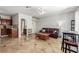 Open-concept living room with tile floors, a ceiling fan, and a comfortable leather couch at 3085 Duneville St, Las Vegas, NV 89146