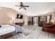 Large main bedroom with sitting area, TV, and ensuite bath, plus hardwood style floors at 3085 Duneville St, Las Vegas, NV 89146