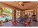 Covered patio with stone pillars, outdoor kitchen, seating area and view of the pool and garden at 3085 Duneville St, Las Vegas, NV 89146