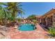 Inviting in-ground swimming pool surrounded by lush landscaping and a rock feature at 3085 Duneville St, Las Vegas, NV 89146