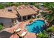 Lovely aerial shot of a backyard featuring a vibrant pool, lounge chairs, and a covered patio, perfect for outdoor entertainment at 3085 Duneville St, Las Vegas, NV 89146