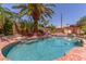 Landscaped backyard pool area with an in-ground pool, rock features, and a cabana at 3085 Duneville St, Las Vegas, NV 89146