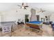 Bright recreation room with a pool table, exercise equipment, and large format tile flooring at 3085 Duneville St, Las Vegas, NV 89146