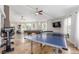 Spacious recreation room featuring a ping pong table, pool table, exercise equipment, and bright natural light at 3085 Duneville St, Las Vegas, NV 89146