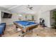 Open recreation area with a pool table, ping pong table, tile flooring, and a mounted television at 3085 Duneville St, Las Vegas, NV 89146
