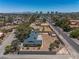 View of the spacious backyard, featuring mature trees and a large lot, with a view of the city skyline at 3090 Westwind Rd, Las Vegas, NV 89146