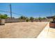 Large, gravel backyard, with mature trees, offering ample space for customization at 3090 Westwind Rd, Las Vegas, NV 89146