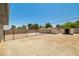 Gravel backyard with storage sheds and a privacy fence at 3090 Westwind Rd, Las Vegas, NV 89146