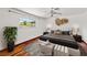Bedroom with hardwood floors and a bed dressed with throw pillows, illuminated by a window with views of foliage at 3090 Westwind Rd, Las Vegas, NV 89146