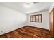 Cozy bedroom showcasing beautiful hardwood floors, natural light from window, and closet for storage at 3090 Westwind Rd, Las Vegas, NV 89146