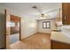 Bright room with wood-look floors, ceiling fan, and adjacent bedroom at 3090 Westwind Rd, Las Vegas, NV 89146