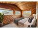 Bedroom featuring wooden walls, large windows, and recessed lighting at 3090 Westwind Rd, Las Vegas, NV 89146
