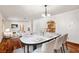Bright dining room featuring hardwood floors, a modern table set, and seamless access to the kitchen and living area at 3090 Westwind Rd, Las Vegas, NV 89146