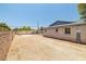 Home exterior showcasing brick accents, gravel side yard, and detached garage at 3090 Westwind Rd, Las Vegas, NV 89146