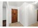 Bright entry foyer with a stylish, carved wood front door and tile flooring at 3090 Westwind Rd, Las Vegas, NV 89146