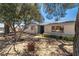 Well-maintained home with desert landscaping, trees, and a brick facade at 3090 Westwind Rd, Las Vegas, NV 89146