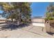 Beautiful home featuring desert landscaping, mature trees, and an attached two-car garage at 3090 Westwind Rd, Las Vegas, NV 89146