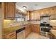 Traditional kitchen features granite countertops, wooden cabinets, stainless steel appliances and tile flooring at 3090 Westwind Rd, Las Vegas, NV 89146