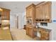 Bright kitchen area with wood cabinets, granite counters, stainless appliances and a built-in desk at 3090 Westwind Rd, Las Vegas, NV 89146