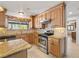 Cozy kitchen features granite countertops, stainless steel appliances and wooden cabinetry at 3090 Westwind Rd, Las Vegas, NV 89146