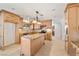 Spacious kitchen with ample cabinets, granite countertops, an island, and modern appliances at 3090 Westwind Rd, Las Vegas, NV 89146