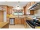 Bright kitchen area features granite countertops, stainless steel appliances and wooden cabinetry at 3090 Westwind Rd, Las Vegas, NV 89146