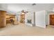 Spacious living area flowing into the kitchen, featuring tile floors and a fireplace at 3090 Westwind Rd, Las Vegas, NV 89146