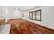 Open living room features hardwood floors, large windows and a fireplace at 3090 Westwind Rd, Las Vegas, NV 89146