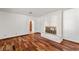 Bright living room features hardwood floors, a brick fireplace and arched doorways at 3090 Westwind Rd, Las Vegas, NV 89146