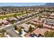Overhead view of a neighborhood featuring mature landscaping and an adjacent golf course with mountain views at 3101 Hayden Ct, Las Vegas, NV 89134