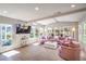 Bright, stylish living room with hardwood floors, large windows, and a chic pink sectional sofa at 3101 Hayden Ct, Las Vegas, NV 89134