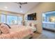 Well-lit main bedroom with a bay window, TV, and an ensuite bathroom at 3101 Hayden Ct, Las Vegas, NV 89134