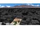 Aerial view of a home in a residential neighborhood with mountain views in the distance at 317 Kane Ave, Las Vegas, NV 89110
