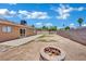 Backyard with stone fire pit and a generous grassy area at 317 Kane Ave, Las Vegas, NV 89110