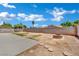 A large backyard has a stone fire pit, perfect for outdoor gatherings at 317 Kane Ave, Las Vegas, NV 89110