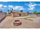 Spacious backyard with a stone fire pit and a comfortable patio area at 317 Kane Ave, Las Vegas, NV 89110