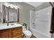 Bathroom featuring a shower-tub combo, single sink vanity, and framed mirror at 317 Kane Ave, Las Vegas, NV 89110