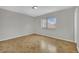 A well-lit bedroom features tile flooring, neutral walls, and a window with blinds at 317 Kane Ave, Las Vegas, NV 89110