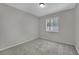 Cozy bedroom featuring carpet flooring, ample lighting, and a neutral color scheme at 317 Kane Ave, Las Vegas, NV 89110