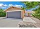 Home's exterior features a wide driveway, well-maintained landscaping, and a two-car garage at 317 Kane Ave, Las Vegas, NV 89110