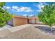 This property features low-maintenance desert landscaping, a two-car garage, and neutral exterior colors at 317 Kane Ave, Las Vegas, NV 89110