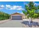 Charming single-story home featuring a two-car garage, landscaped yard, and desert rock at 317 Kane Ave, Las Vegas, NV 89110