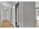 Hallway featuring an open closet with shelving, doors to other rooms and tile flooring at 317 Kane Ave, Las Vegas, NV 89110