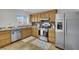 Traditional kitchen with stainless steel appliances, light wood cabinets, and tile backsplash at 317 Kane Ave, Las Vegas, NV 89110