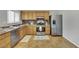 Bright kitchen with stainless steel appliances, wooden cabinets, and tiled flooring at 317 Kane Ave, Las Vegas, NV 89110
