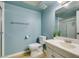 Bright bathroom featuring tile flooring, toilet, and vanity sink with mirror at 3785 Decade St, Las Vegas, NV 89121
